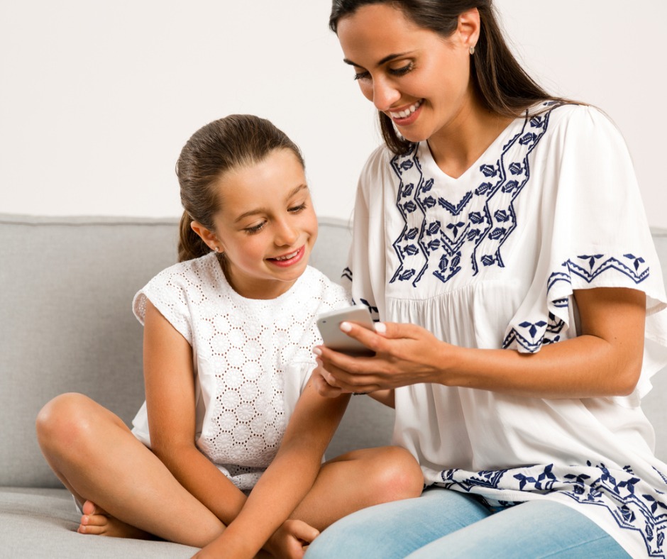 Mom teaching child to use the phone