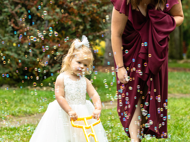 Professional wedding childcare with children enjoying supervised activities during a reception